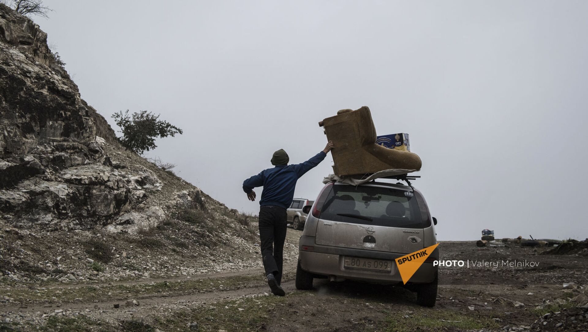 Мужчина с перегруженным вещами автомобилем покидает свой дом в городе Бердзор (30 ноября 2020). Карабах - Sputnik Արմենիա, 1920, 08.09.2021