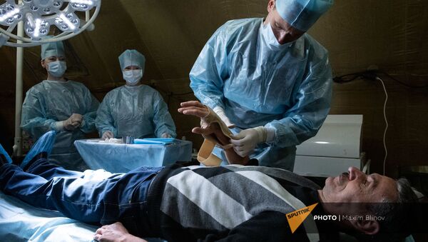 Медик оказывает помощь пациенту на базе полевого госпиталя развернутого Минобороны России на территории аэропорта в Степанакерте (1 декабря 2020). Карабах - Sputnik Արմենիա