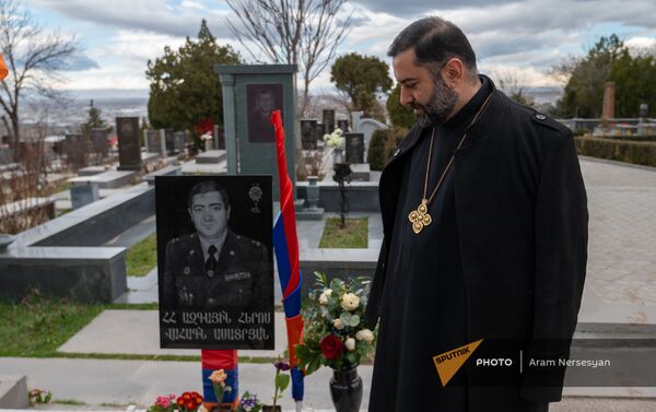 Капеллан Манук Зейналян у могилы своего командира, Национального героя Ваагна Асатряна в военном пантеоне Ераблур - Sputnik Армения