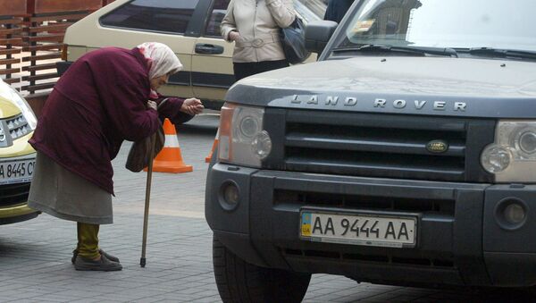 Пожилая женщина просит денег у водителей проезжающих автомобилей в центре Киева (29 марта 2007). Украина - Sputnik Արմենիա