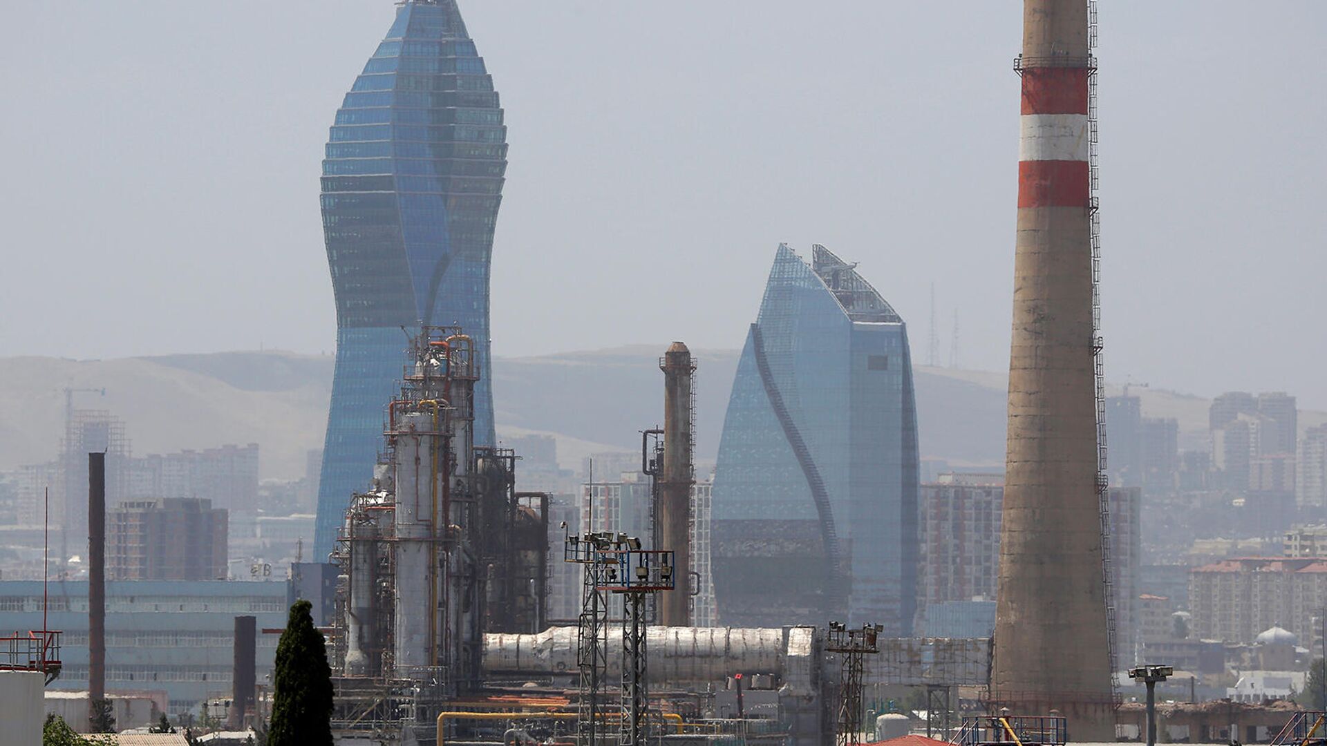 Бакинский нефтеперерабатывающий завод имени Гейдара Алиева виден на фоне небоскреба Socar Tower в Баку - Sputnik Армения, 1920, 25.04.2022