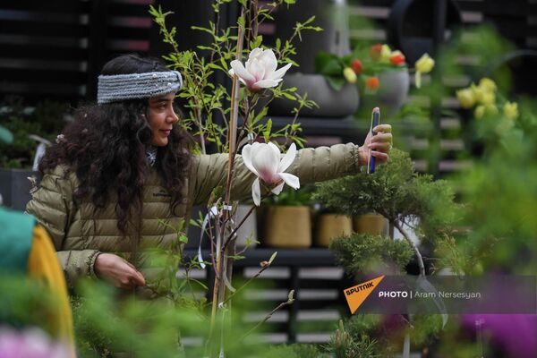 Երիտասարդ աղջիկը նկարվում է ծաղկային տոնավաճառում - Sputnik Արմենիա