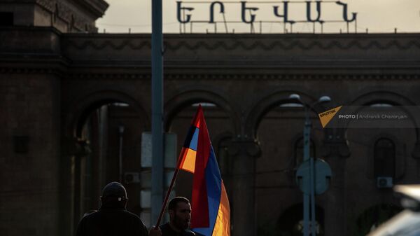Участники марша осведомленности Проснись, Лао с флагами у железнодорожной станции Ереван (25 апреля 2022). Еревaн - Sputnik Армения