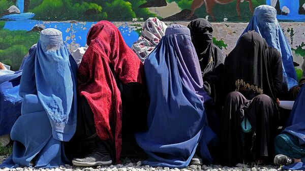 Женщины ждут, чтобы получить продовольственные пайки, раздаваемые саудовской группой гуманитарной помощи, в Кабуле (25 апреля 2022). Афганистан - Sputnik Армения