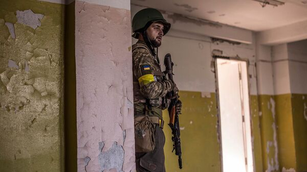 Украинский солдат укрывается во время боев в Северодонецке - Sputnik Армения