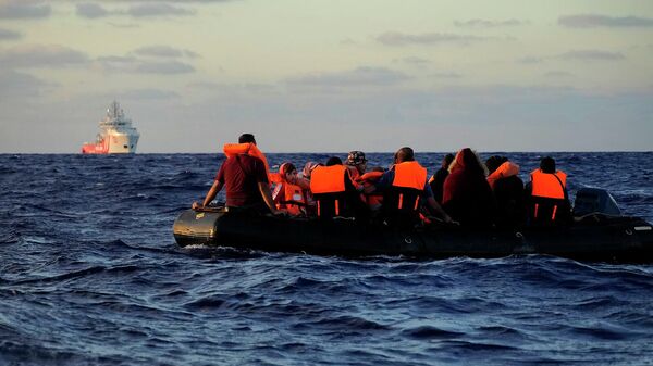 Резиновая лодка с мигрантами в международных водах зоны Ливии SAR (Search and Rescue) в Средиземном море - Sputnik Армения