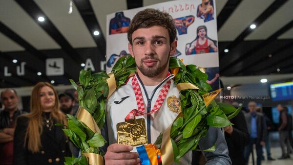 Чемпион Европы Арсен Арутюнян показывает свою золотую медаль в аэропорту Звартноц по возвращении на родину (21 апреля 2023). Еревaн - Sputnik Армения