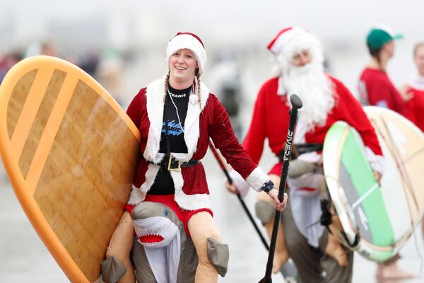 Участники ежегодного заплыва серферов в костюмах Санта-Клауса в США  - Sputnik Армения