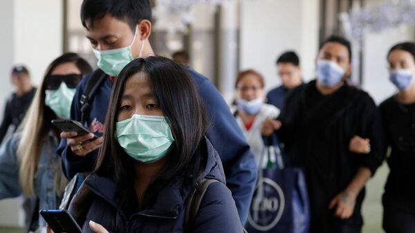 Пассажиры из Китая в медицинских масках в Международном аэропорту Манилы (23 января 2020). Филиппины - Sputnik Արմենիա