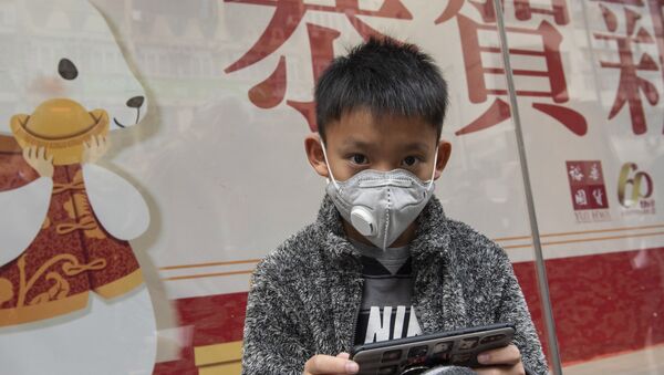 Мальчик в защитной маске на одной из улиц в Гонконге. - Sputnik Армения